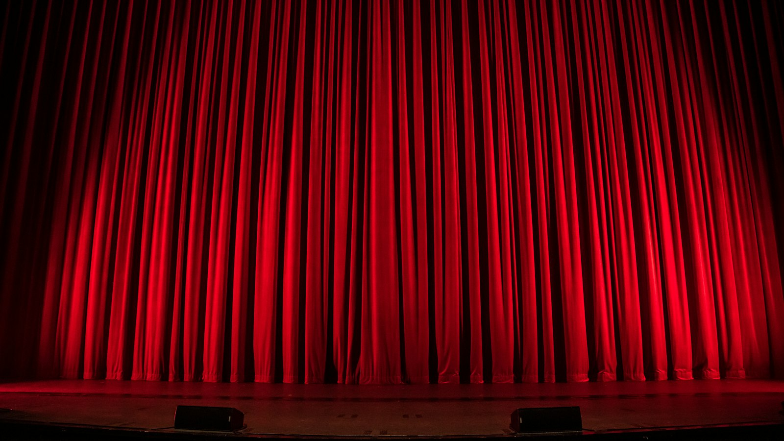 Warm stage lights in a theatre, representing Vernon, BC's performing arts scene