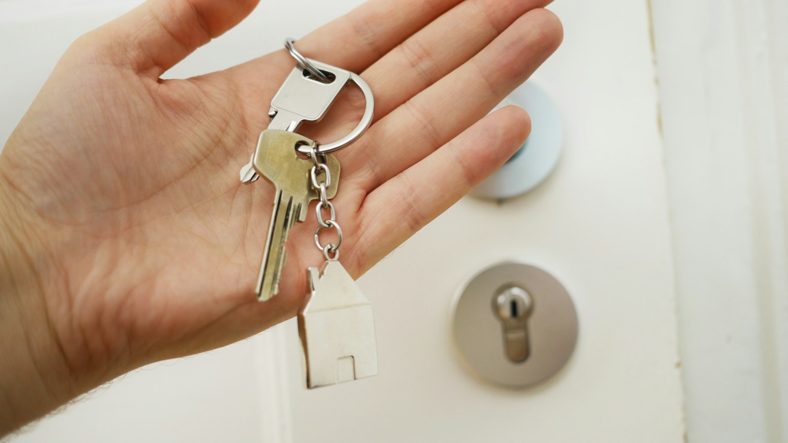 First-time home buyers standing outside their new home in Vernon, BC