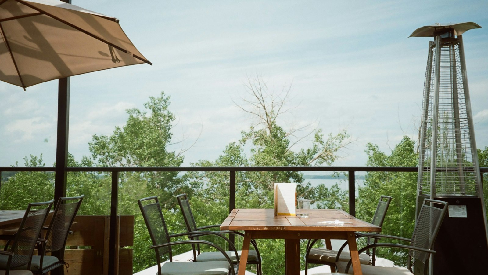Restaurant patio tables overlooking Okanagan Lake near Vernon, BC on a sunny afternoon