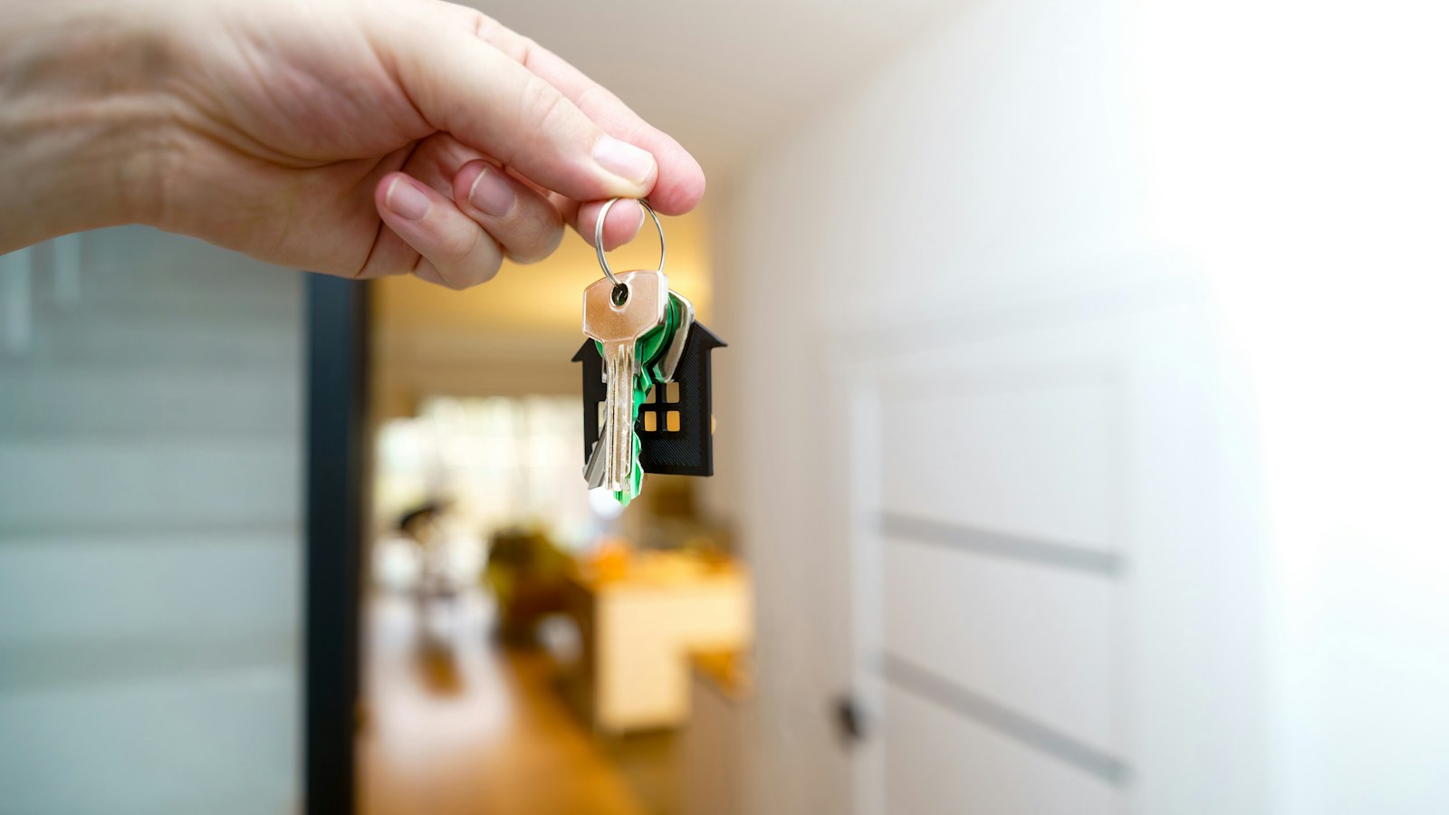 A handshake over house keys, illustrating representation for buyers and sellers in a BC real estate deal