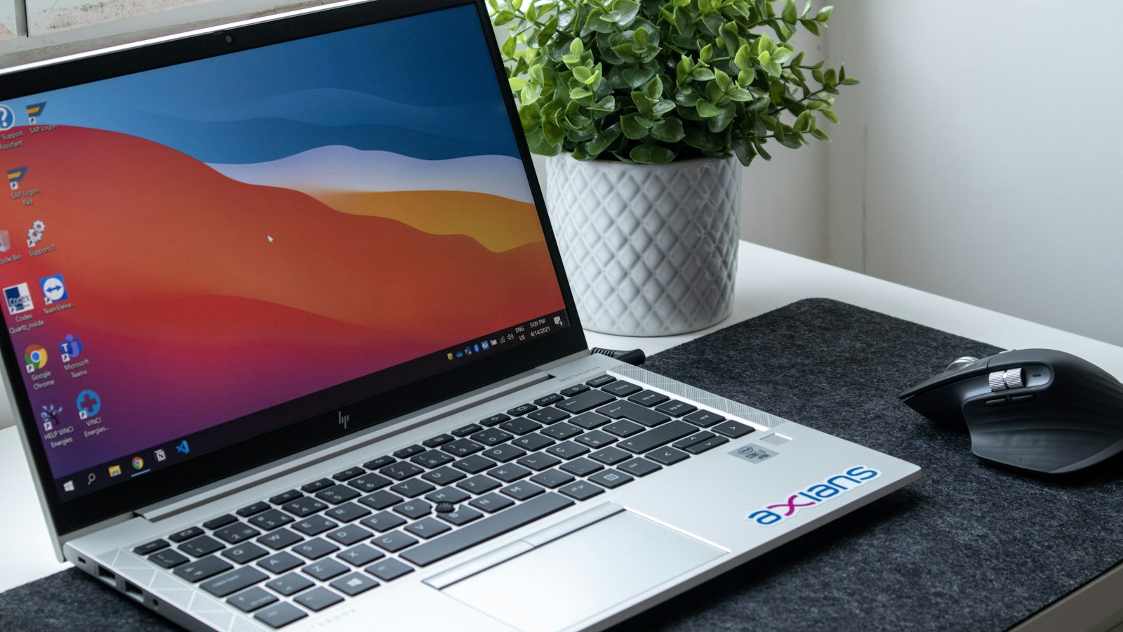 A laptop open on a desk in a bright home office, representing the tools a modern Vernon real estate agent uses