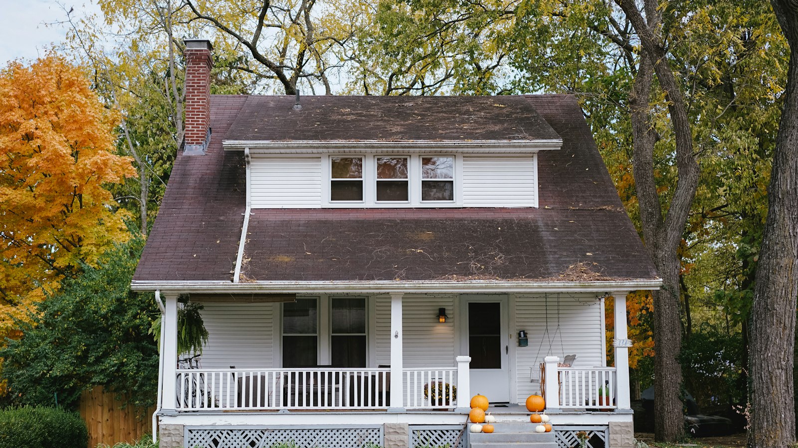 A home with a for sale sign on the lawn, representing a BC homeowner deciding whether to sell privately
