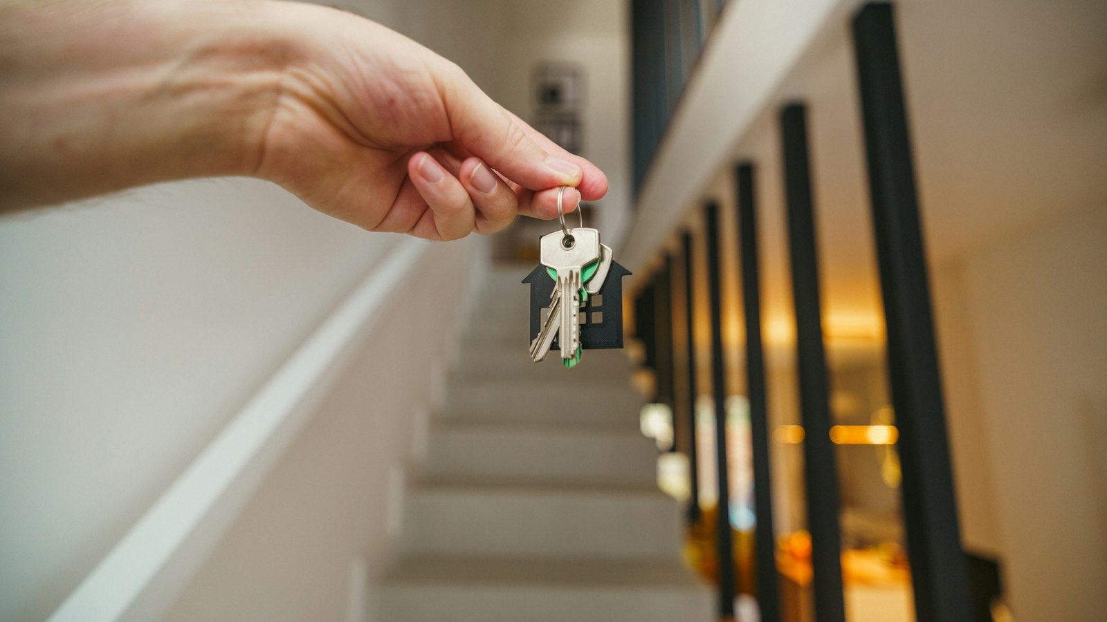 First-time buyers holding the keys to their new home in Vernon, BC