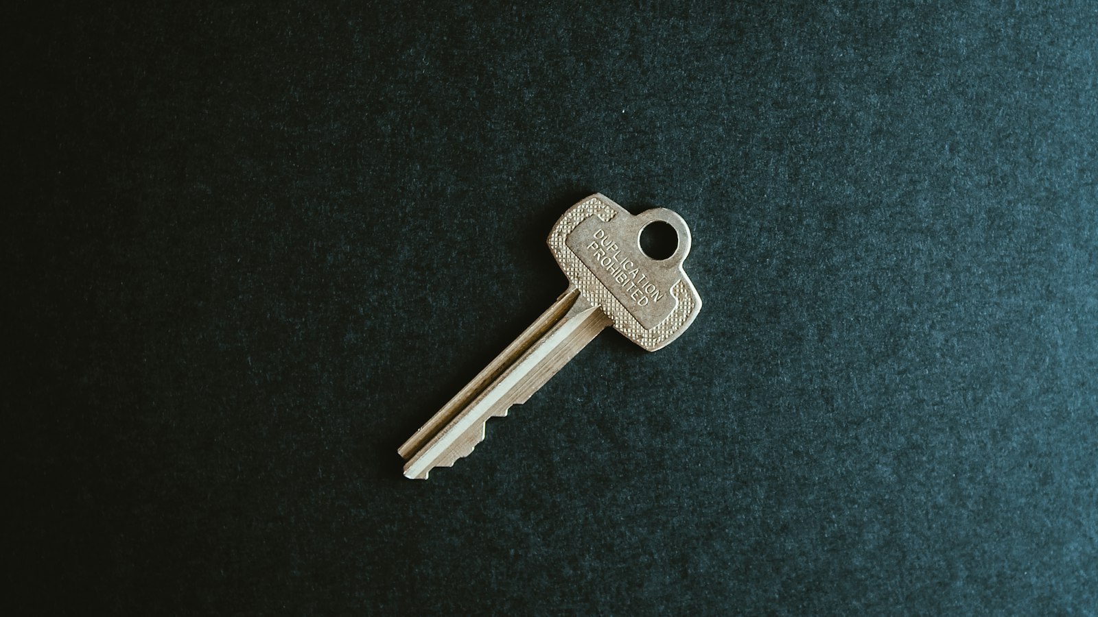 A calculator and house keys on a table, representing a seller reviewing realtor commission in BC